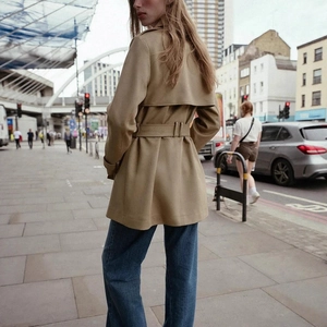 Women's mid-length khaki faux suede trench coat with waist belt and back wind flap