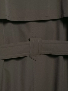 Macro detail of dark taupe windbreaker featuring storm flap and reinforced belt loop