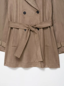 Detail view of brown faux suede trench coat featuring classic double-breasted buttons and belt