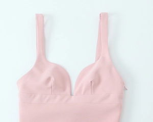 Detailed view of pink mini dress featuring a deep V-neckline and side invisible zipper