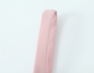 Detailed close-up of soft pink fabric texture and stitching on the mini bow dress