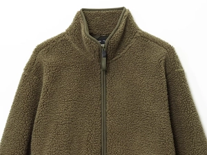 Detail of olive green teddy fleece jacket showing high neck zipper and soft fuzzy texture