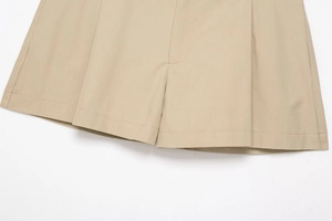Detail of khaki twill shorts featuring precision double-stitched hem and box pleat design