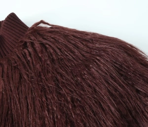 Detailed macro view of dark burgundy knit collar and soft faux fur texture on the garment