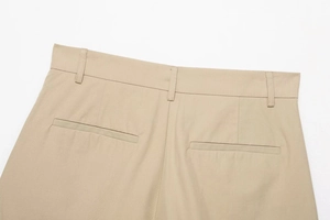 Detailed view of the khaki trousers showing belt loops and symmetrical back pockets