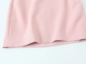 Detailed view of pink mini dress hem with high-quality stitching and thick fabric texture