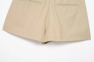 Detail view of khaki twill shorts featuring symmetrical back pockets and precise stitching