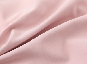 Detailed macro view of soft pink woven fabric texture for this short bow dress