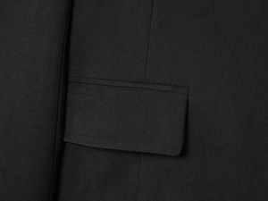 Close-up of side flap pocket and fine twill texture on women black casual blazer