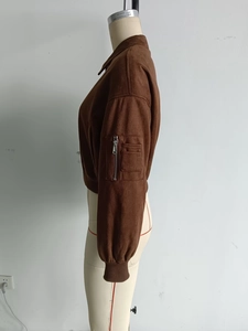 Detail einer dunkelbraunen Bomberjacke aus Wildleder mit Ärmeltasche und Texturansicht