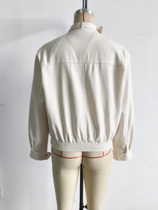 Back view of a creamy white loose jacket featuring stand collar and elastic hem detail