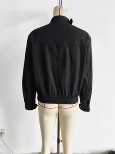 Back view of a black casual bomber jacket with ribbed hem and T-shaped seam detailing