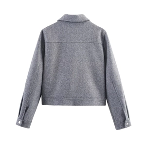 Detailed back view of a grey cropped jacket showing thick textured fabric and silver buttons
