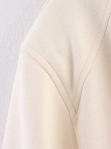 Detailed close-up showing the precise stitching and premium fabric texture of the jacket