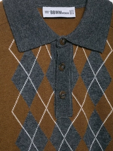 Detail of argyle knit polo sweater featuring grey collar and tortoiseshell buttons