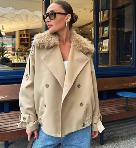 Detail of khaki double-breasted trench coat with a plush brown faux fur collar