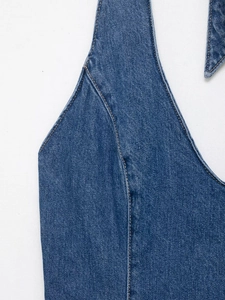 Detail of blue denim halter top showing yellow contrast stitching and premium washed fabric