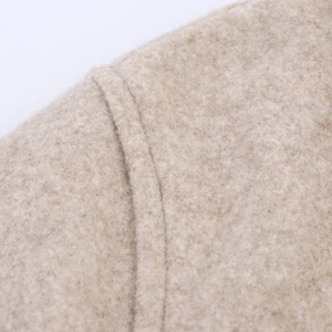 Macro shot of high-quality beige wool fabric texture and fine stitching on the soft jacket