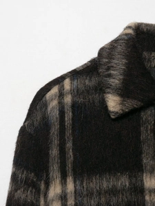 Detailed close-up showing the premium plaid texture and soft wool-blend fabric of the coat