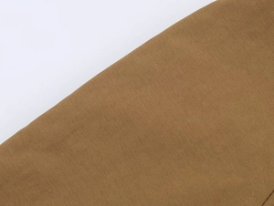 Detailed macro view of khaki twill fabric texture for short reversible trench coats