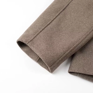Close-up of brown wool coat cuff with detailed texture and premium stitching