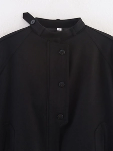 Detail of the high collar and black resin buttons on this loose-fit black winter jacket