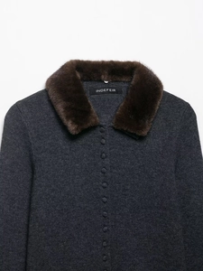 Close-up of charcoal gray knit cardigan with plush faux fur collar and textured buttons