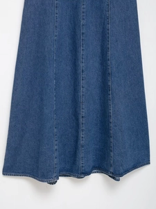Detailed stitching and washed denim texture of a dark blue halter neck denim dress