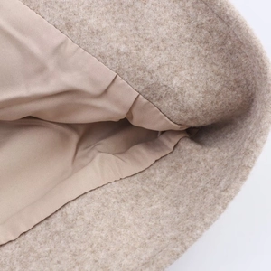 Detailed macro view of beige wool fabric texture and smooth silk-like inner lining