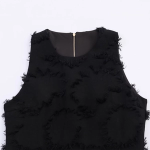 Elegant black sleeveless top with textured fringe fabric and a golden back zipper detail