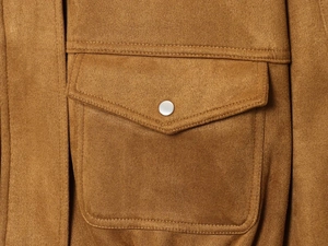 Macro detail of brown faux suede flight jacket featuring front flap pocket and silver snap