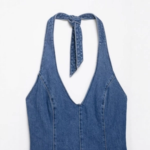 Halter neck dark blue denim dress with deep V-neckline and decorative stitching details