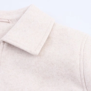 Close-up of cream soft wool zipper jacket showing lapel and premium fabric texture