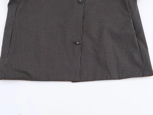 Detailed view of dark grey plaid fabric texture and premium black round buttons