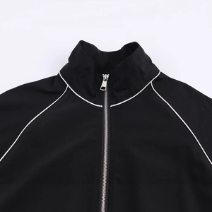 Black nylon bomber jacket with stand collar and white contrast piping on the shoulders