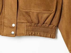 Detail of caramel brown suede jacket featuring elastic hem and silver metal snap buttons