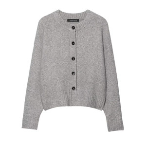 Minimalist grey knit cardigan with round neck and black contrast buttons on white background