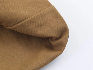Macro shot of durable mustard brown twill fabric texture and high-density stitching details