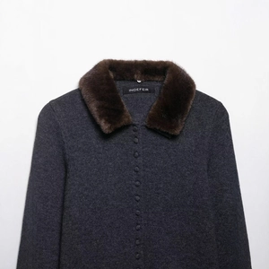 Dark grey knitted jacket with brown faux fur lapel and fabric buttons in a frontal view