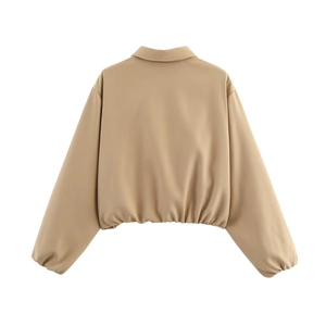 Back view of a khaki puffer jacket with elastic hem and drop shoulders for women