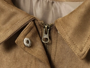 Detailed close-up of brown suede jacket collar with bronze zipper and metal snap button