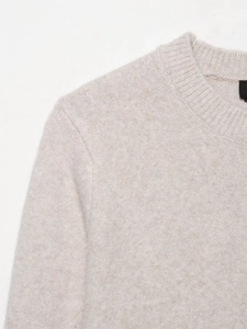 Close-up of oatmeal knit cardigan showing ribbed neckline and fine texture