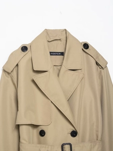 Detail of khaki trench coat with classic lapels, epaulettes, and double-breasted buttons