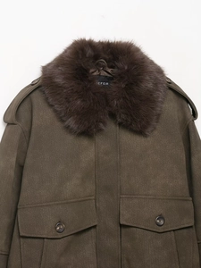 Detail view of olive faux suede jacket featuring a large brown faux fur collar and pockets