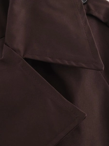 Close-up of dark brown trench coat featuring premium twill fabric and reinforced stitching