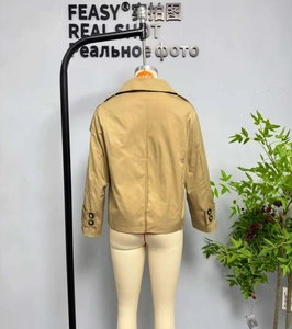 Detail of khaki twill jacket showing zipper closure, collar, and sleeve adjustment buckle