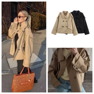 Detail view of khaki and black double-breasted short trench coats with belted cuffs