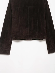 Detail of dark brown faux suede jacket featuring double stitching on hem and cuffs