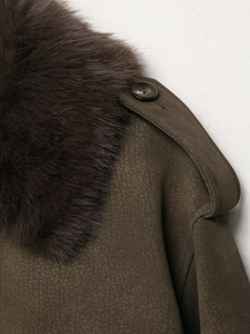 Close-up of olive green faux suede jacket with detachable brown faux fur collar