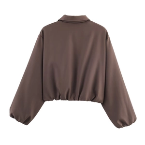 Rear view of a chocolate brown cropped puffer jacket with elastic hem and sleek finish